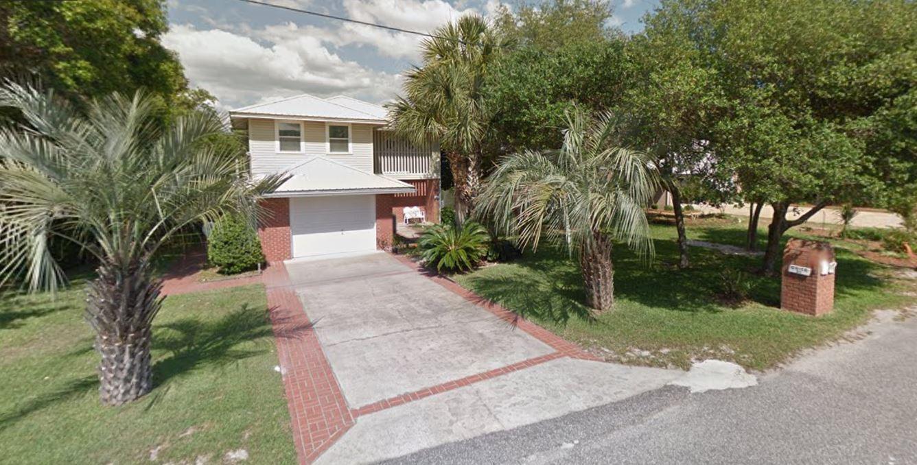 95 Blue Lake Road Santa Rosa Beach, FL 32459 - Photo 11 of 11 a front view of a house with a yard and trees