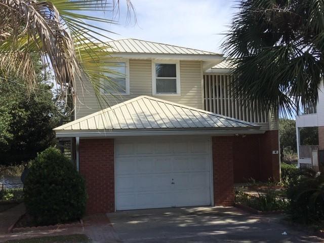 95 Blue Lake Road Santa Rosa Beach, FL 32459 - Photo 3 of 11 a front view of a house with a garden