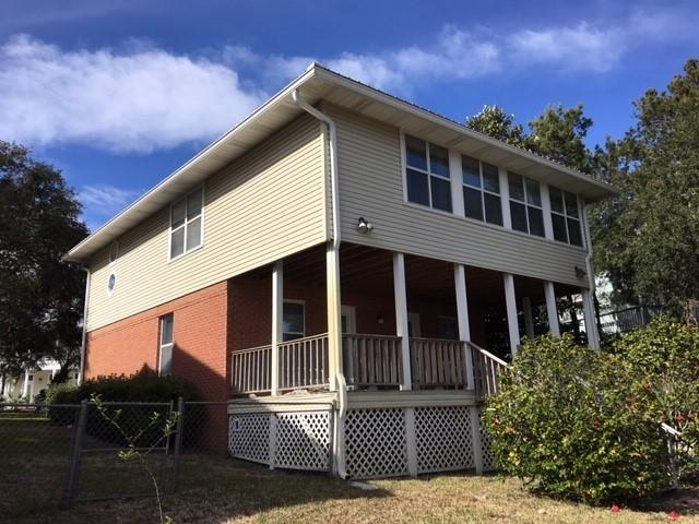 95 Blue Lake Road Santa Rosa Beach, FL 32459 - Photo 4 of 11 a front view of a house with a garden