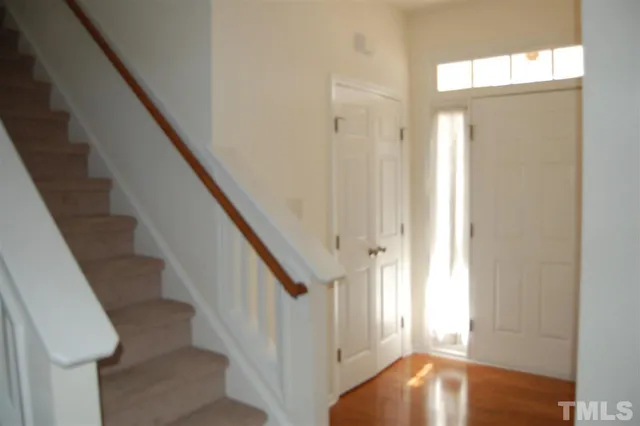 a view of entryway with wooden floor and stair