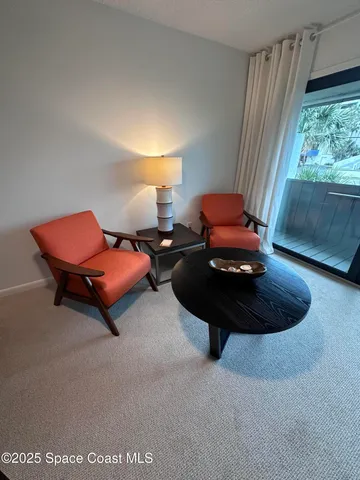 a living room with furniture and a lamp