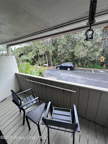 a view of a chairs and table in the balcony