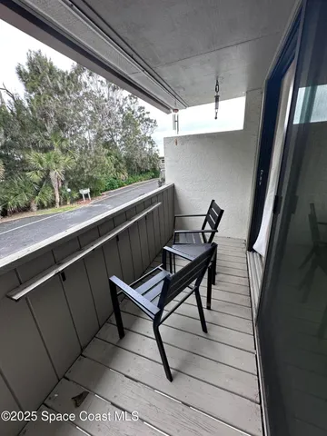 a view of balcony with furniture