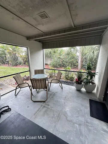 a view of a porch with furniture and a yard