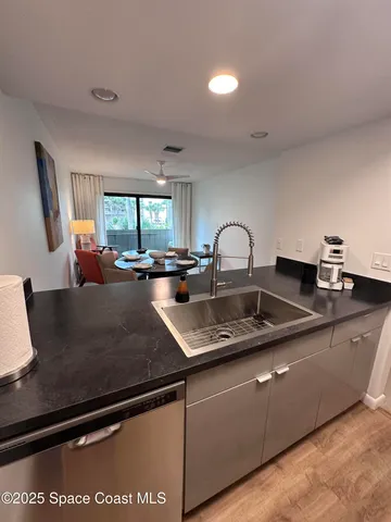 a kitchen with granite countertop a sink and a stove top oven