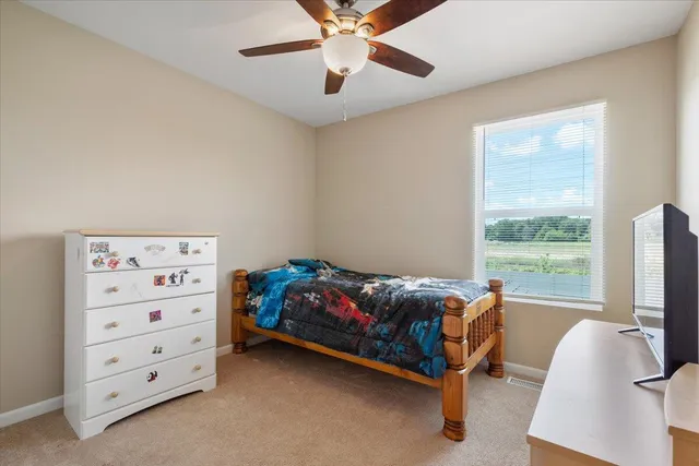 a bed room with a bed and a window