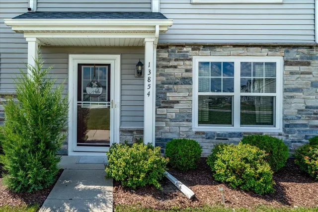 a view of a brick house with large windows