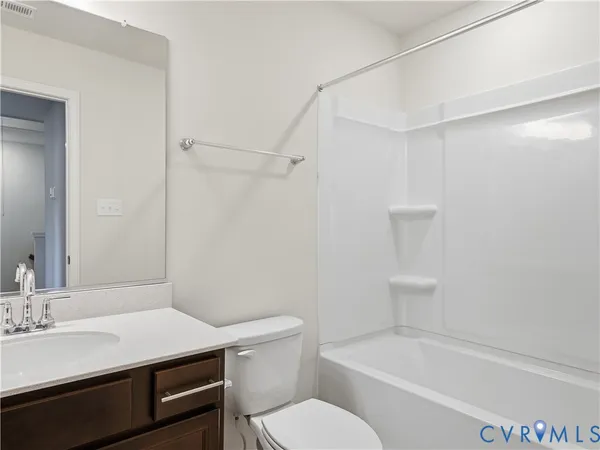 a bathroom with a sink toilet vanity and bathtub