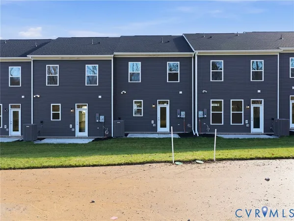 a view of a brick house with a swimming pool and a big yard