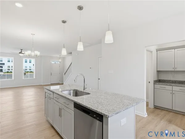 a kitchen with a sink cabinets and wooden floor