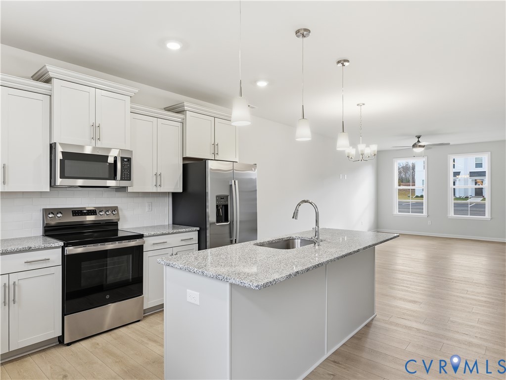 334 Mt Mccauley Way Aylett, VA 23009 - Photo 6 of 20 a kitchen with kitchen island a sink stainless steel appliances and counter space