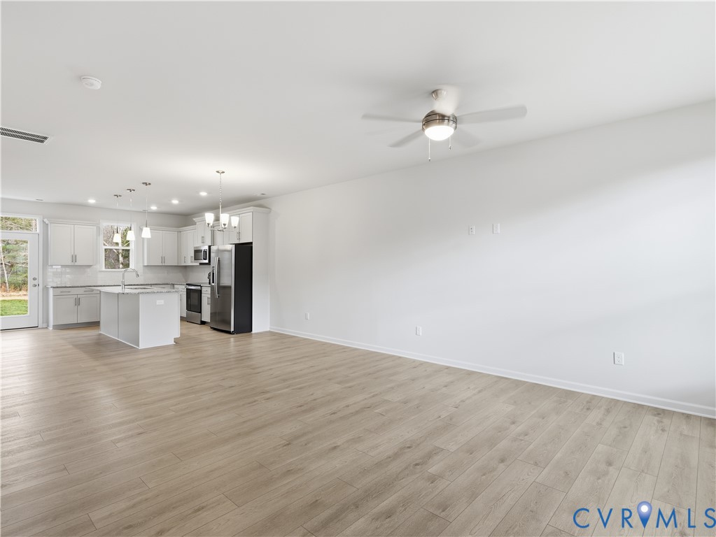 334 Mt Mccauley Way Aylett, VA 23009 - Photo 8 of 20 a view of kitchen with kitchen island wooden floor and ceiling fan