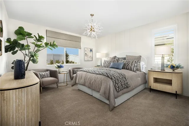 a spacious bedroom with a bed and a chandelier