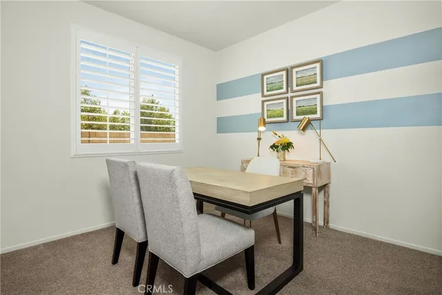 a view of a dining room with furniture and window