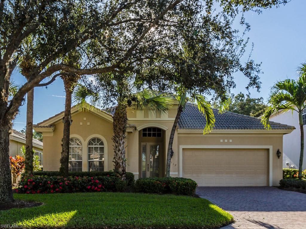 a front view of a house with a garden and plants