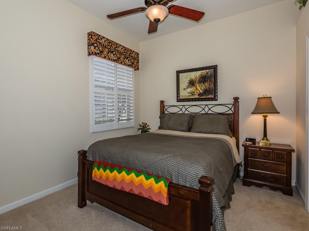 20117 Seadale Court Estero, FL 33928 - Photo 11 of 35 a bedroom with a bed and a tv
