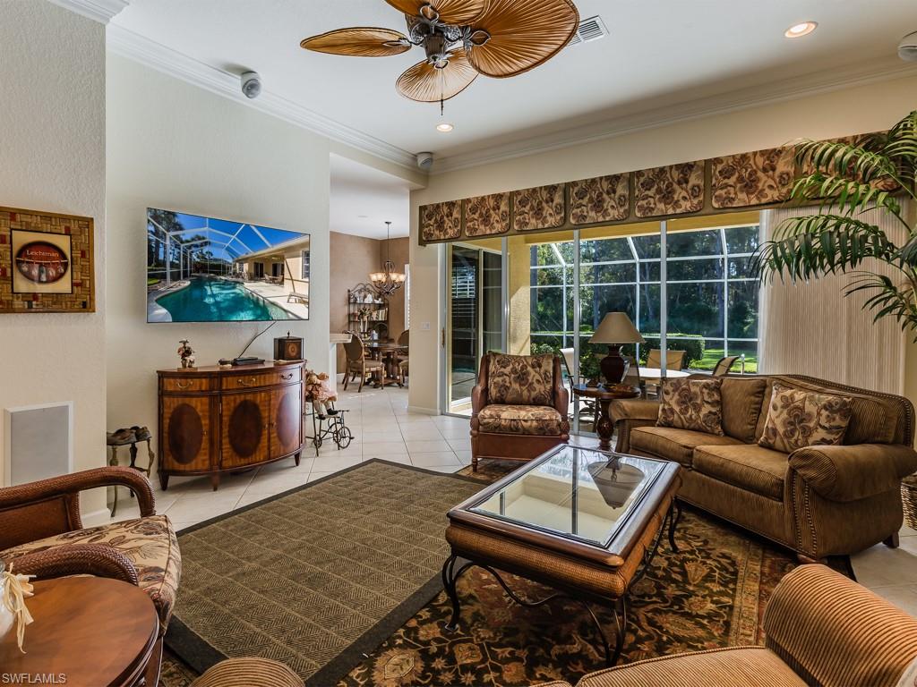 20117 Seadale Court Estero, FL 33928 - Photo 2 of 35 a living room with furniture a fireplace and a flat screen tv