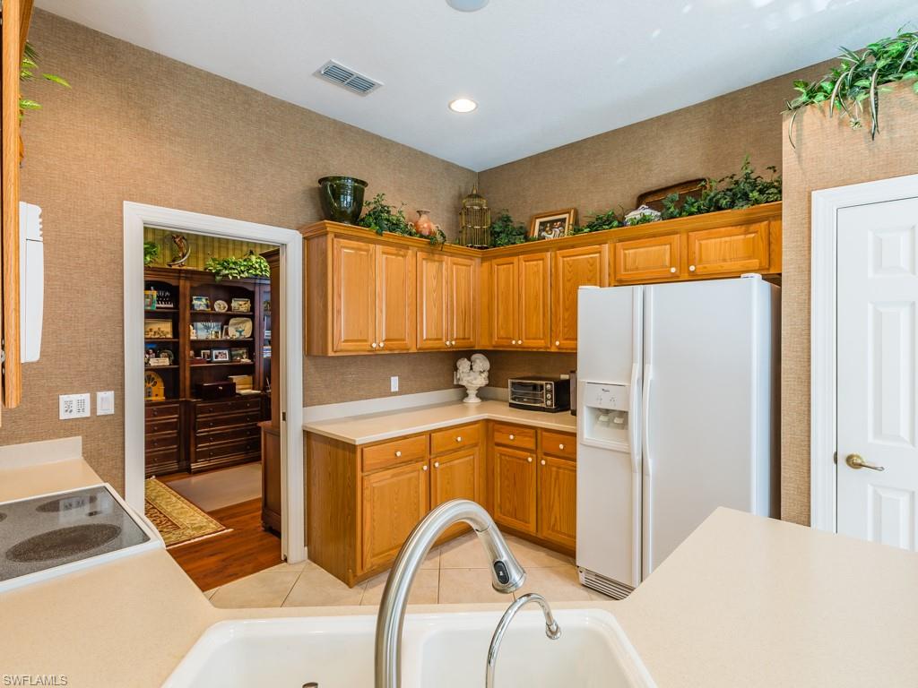 20117 Seadale Court Estero, FL 33928 - Photo 3 of 35 a kitchen with stainless steel appliances granite countertop a refrigerator and a stove top oven