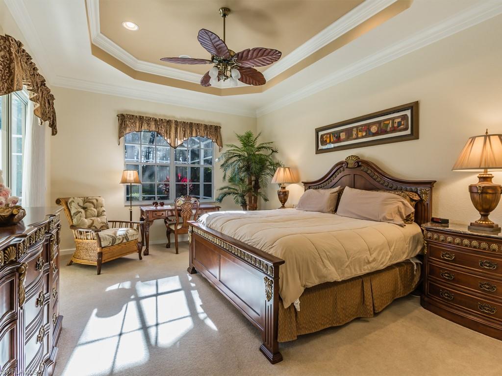 20117 Seadale Court Estero, FL 33928 - Photo 7 of 35 a spacious bedroom with a bed and a chandelier
