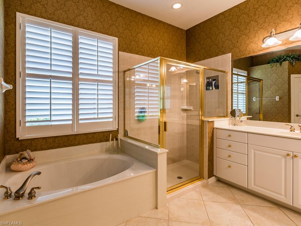 20117 Seadale Court Estero, FL 33928 - Photo 9 of 35 a bathroom with a tub sink and mirror