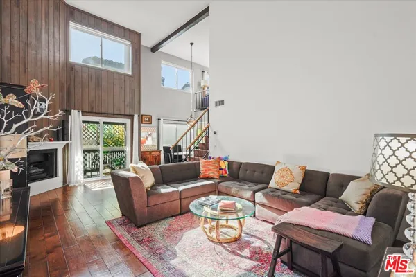 a living room with furniture fireplace and a large window