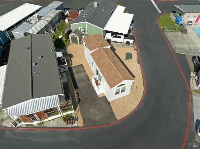 an aerial view of a kitchen with a table and chairs