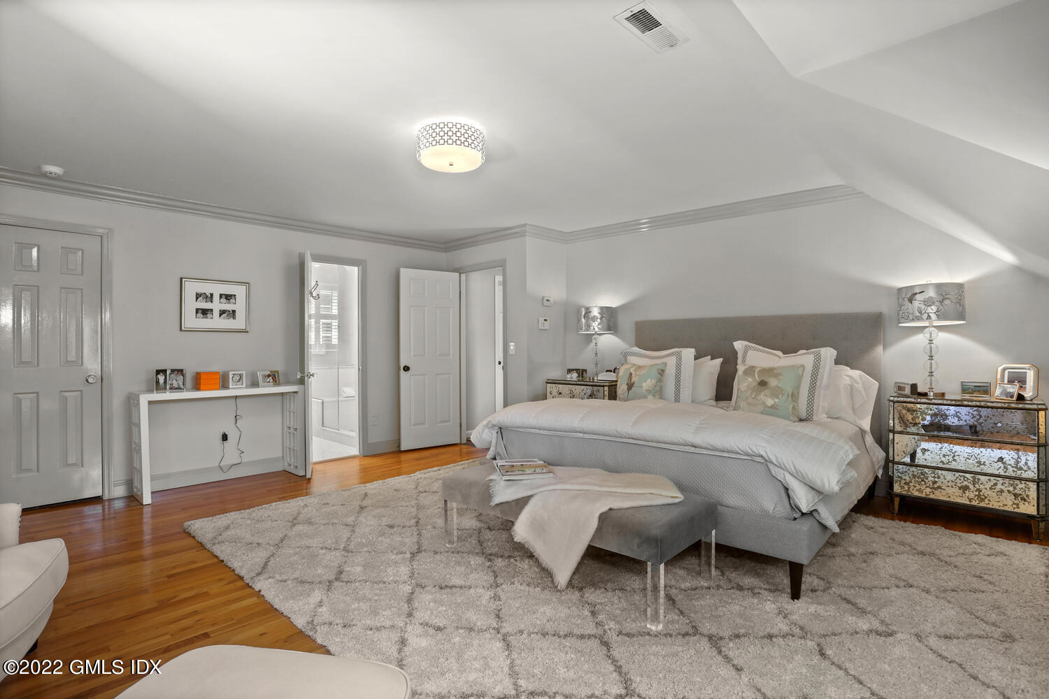 47 Druid Lane Riverside, CT 06878 - Photo 14 of 29 a spacious bedroom with a bed and a table