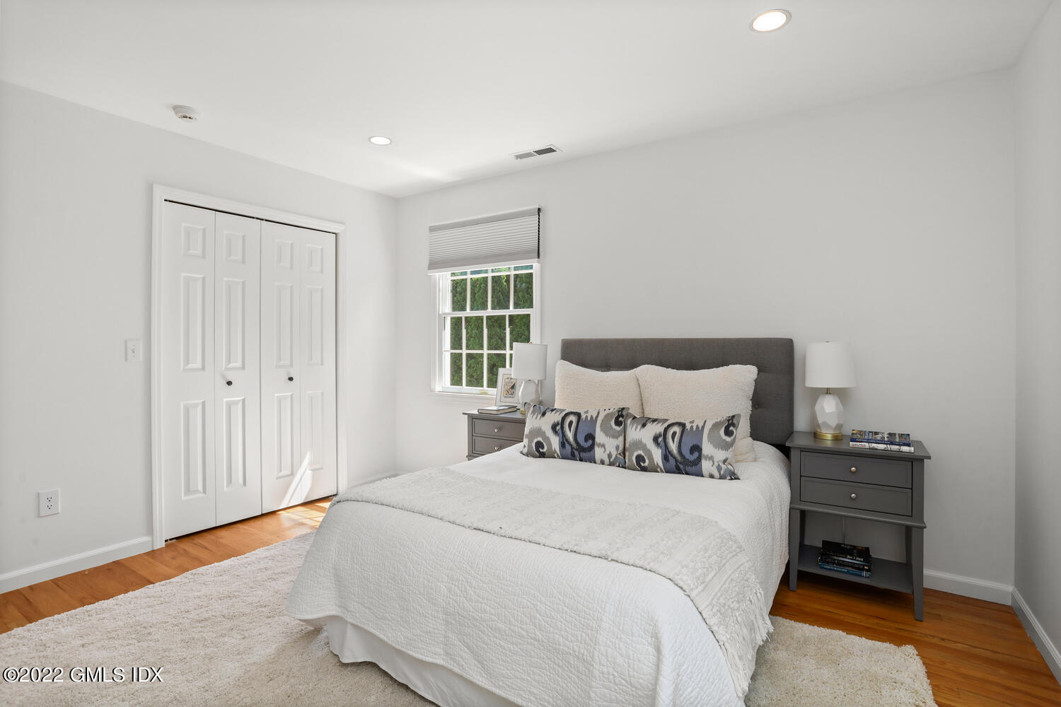 47 Druid Lane Riverside, CT 06878 - Photo 17 of 29 a bedroom with a bed and a window