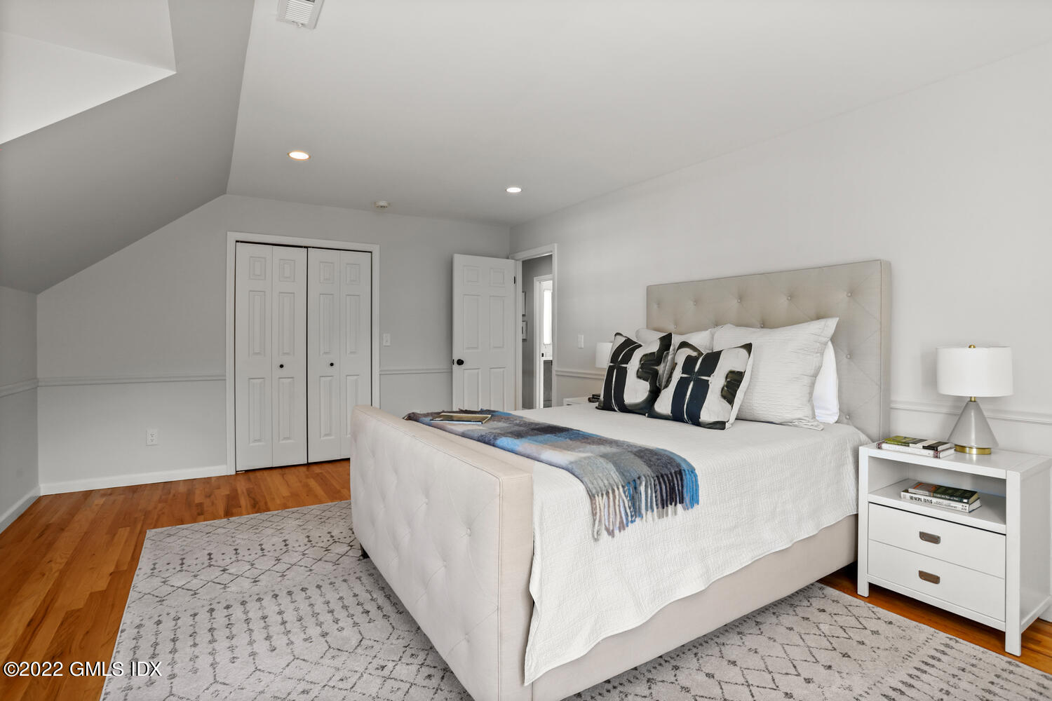 47 Druid Lane Riverside, CT 06878 - Photo 18 of 29 a bed room with a bed and a lamp