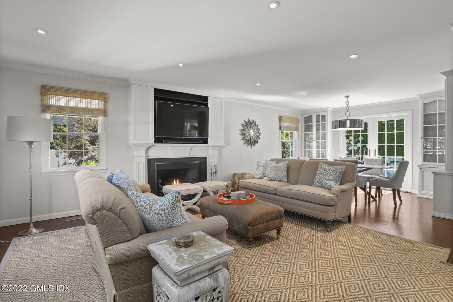 47 Druid Lane Riverside, CT 06878 - Photo 2 of 29 a living room with furniture a flat screen tv and a fireplace