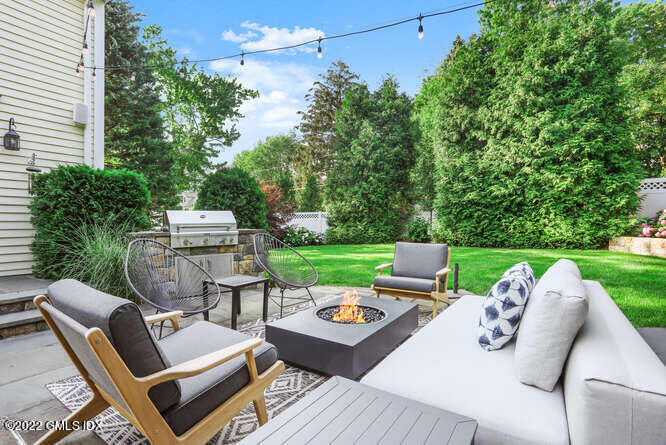 47 Druid Lane Riverside, CT 06878 - Photo 22 of 29 a view of a patio with couches chairs and a table
