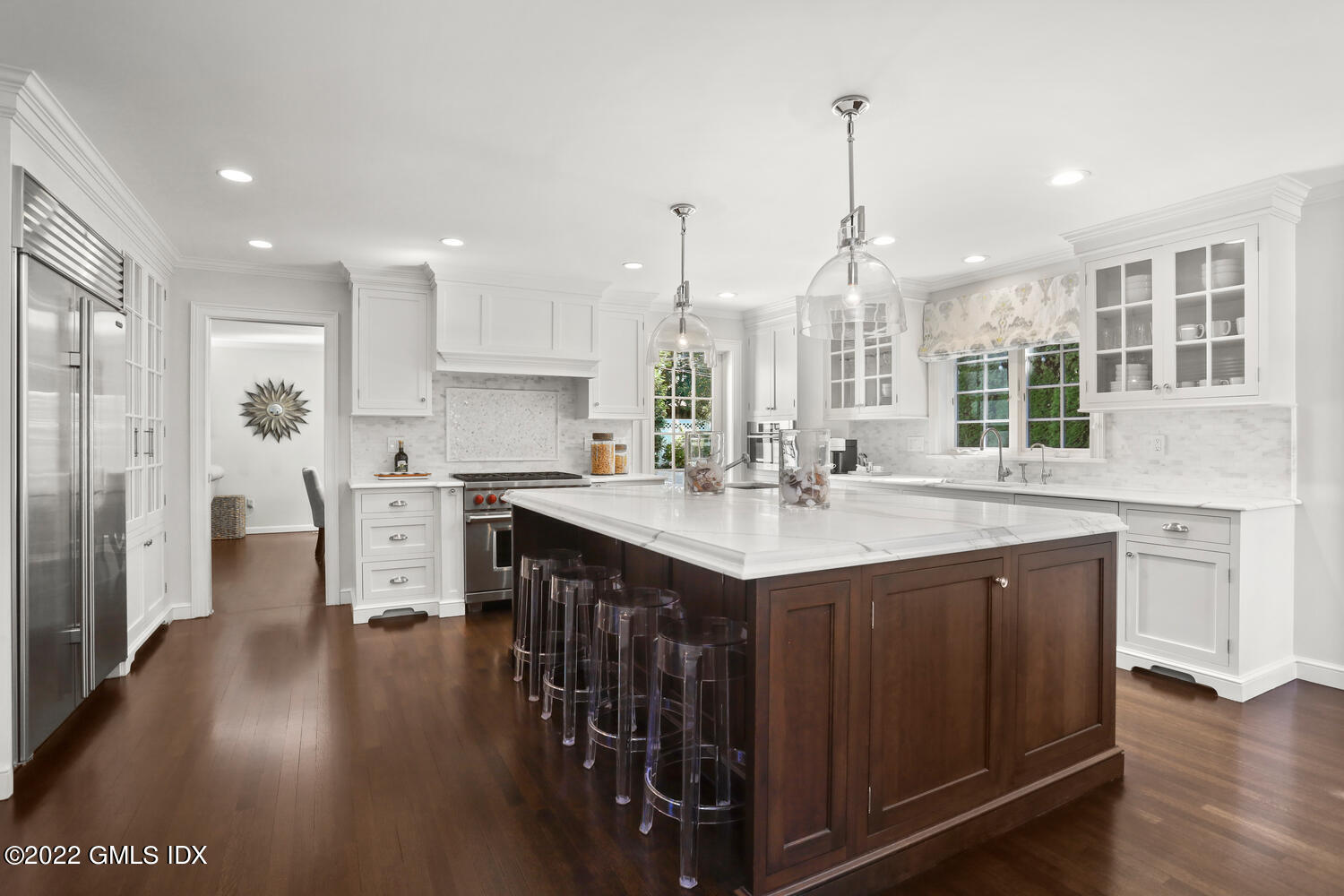 47 Druid Lane Riverside, CT 06878 - Photo 5 of 29 a kitchen with stainless steel appliances granite countertop a sink stove and wooden floor