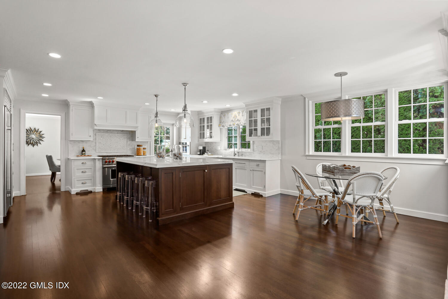 47 Druid Lane Riverside, CT 06878 - Photo 6 of 29 a open dining room with stainless steel appliances kitchen island granite countertop a dining table chairs and view living room