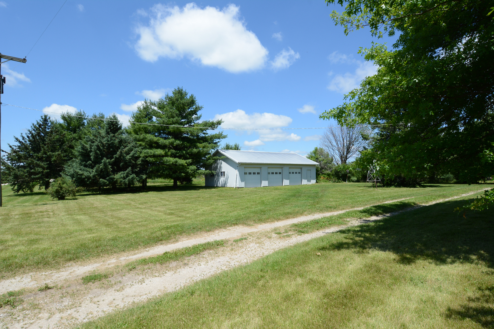 6115 South University Road Shabbona, IL 60550 - Photo 2 of 37 a view of a golf course with a lake