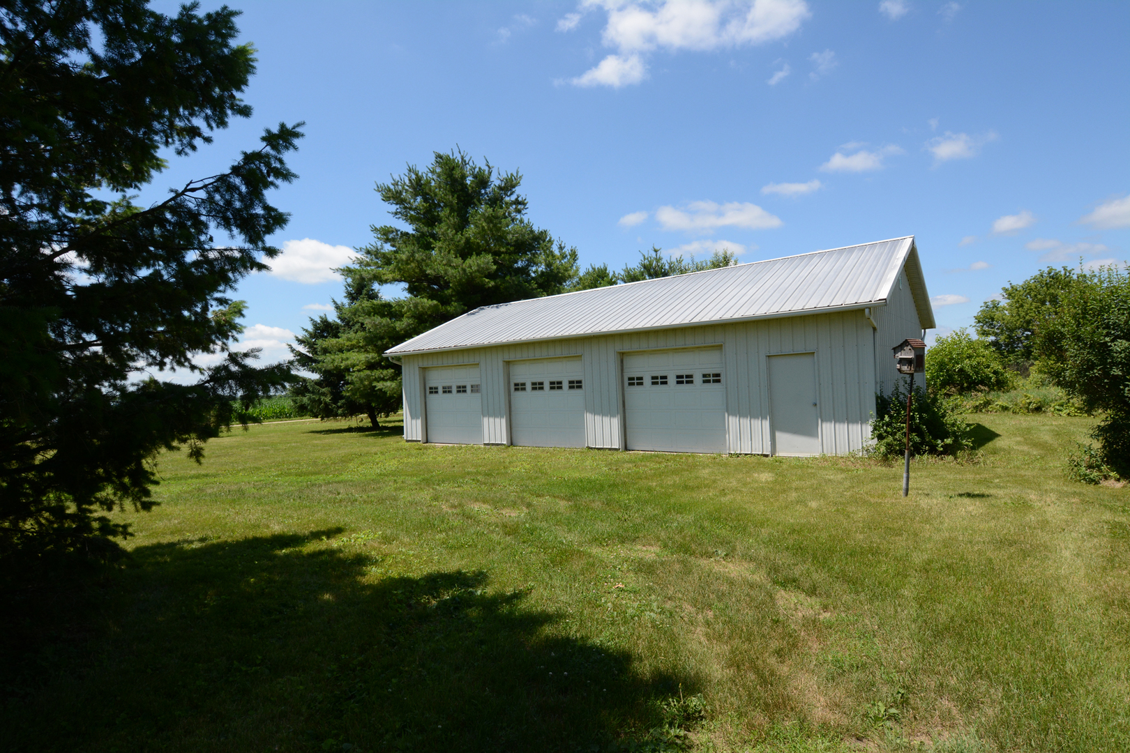 6115 South University Road Shabbona, IL 60550 - Photo 13 of 37 a view of a house with a big yard and large trees