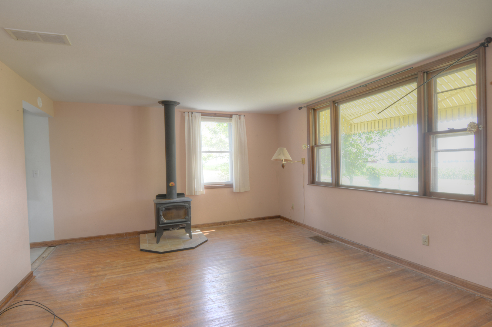 6115 South University Road Shabbona, IL 60550 - Photo 19 of 37 an empty room with wooden floor and windows