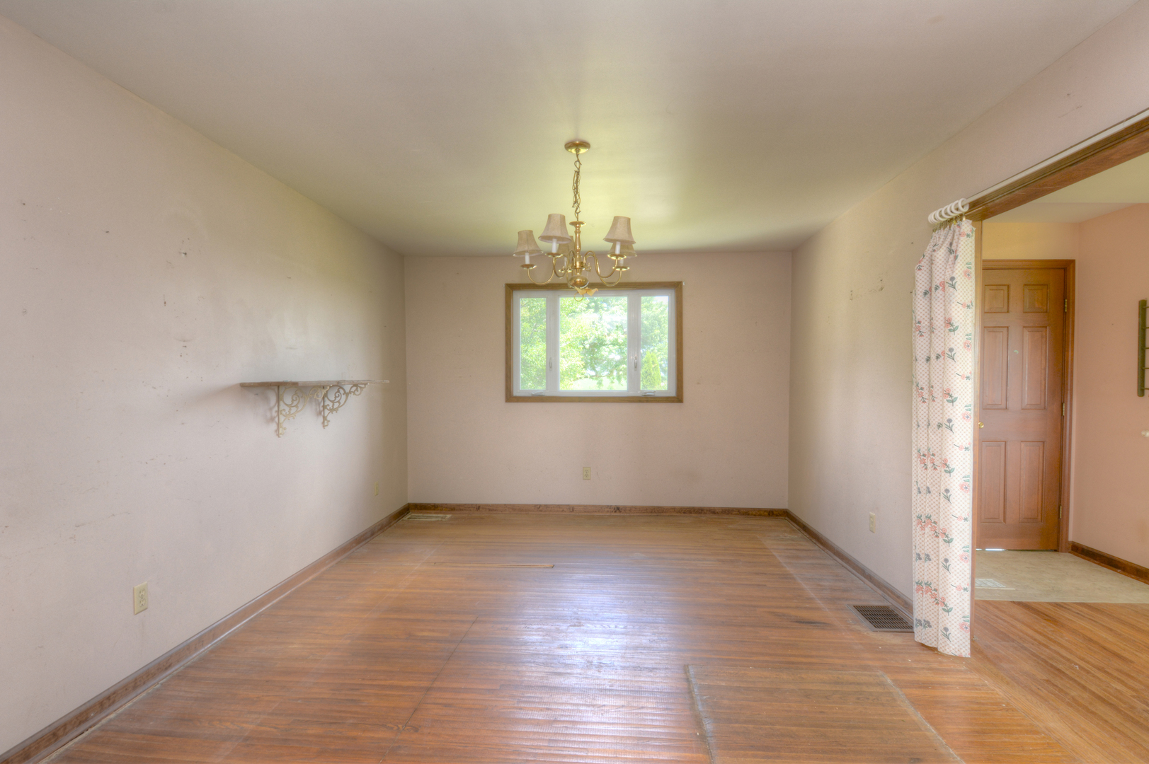 6115 South University Road Shabbona, IL 60550 - Photo 20 of 37 an empty room with wooden floor chandelier and windows