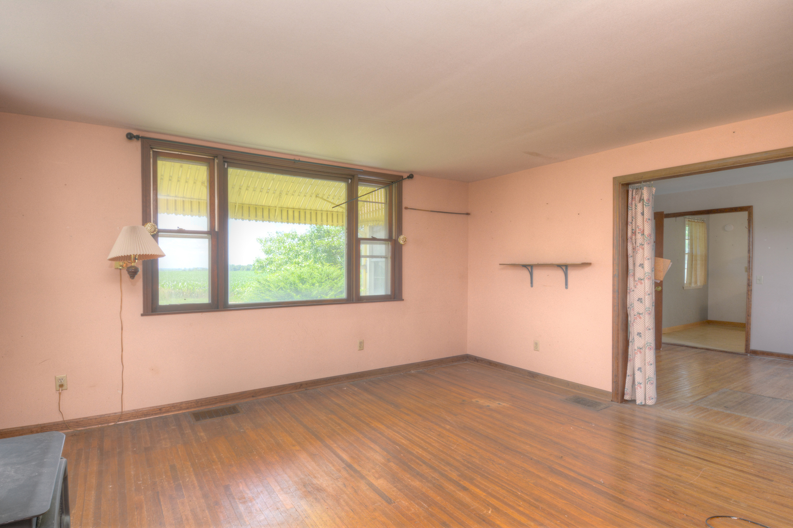 6115 South University Road Shabbona, IL 60550 - Photo 24 of 37 a view of an empty room with wooden floor and a window