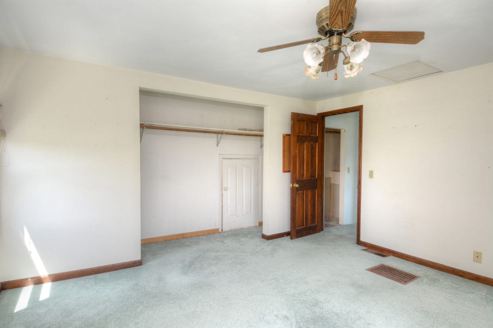 6115 South University Road Shabbona, IL 60550 - Photo 31 of 37 an empty room with closet and a chandelier fan
