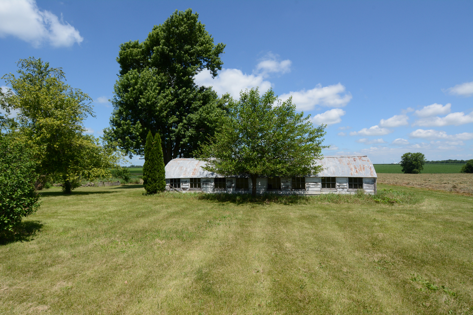 6115 South University Road Shabbona, IL 60550 - Photo 8 of 37 a view of a swimming pool and trees in the background