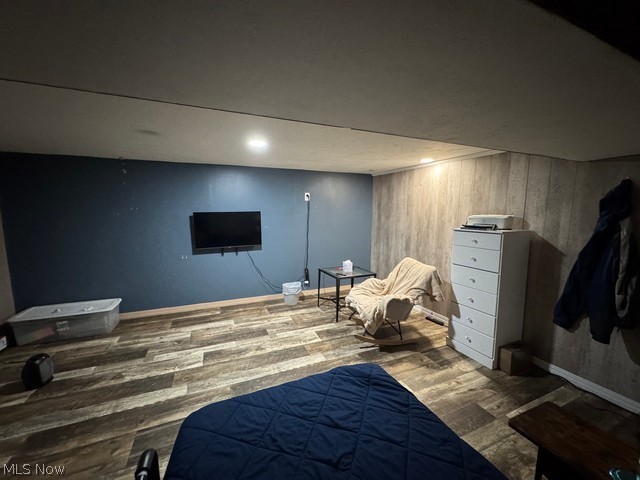 620 Ravenna Road Newton Falls, OH 44444 - Photo 10 of 23 Wood-finish flooring throughout, complemented by a feature wall with a dark blue finish and a second wall with vertical wood paneling