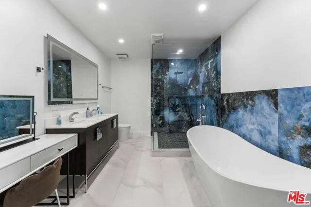 a bathroom with a double vanity sink mirror and toilet