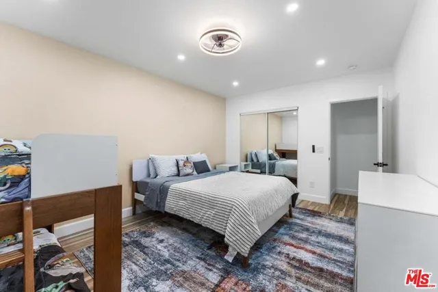 a bedroom with a bed and a large mirror