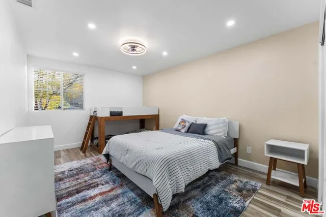 a bedroom with a bed and a chair