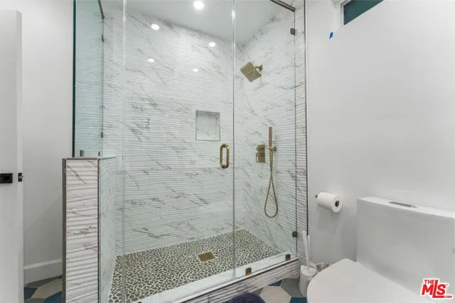 a bathroom with a shower and toilet