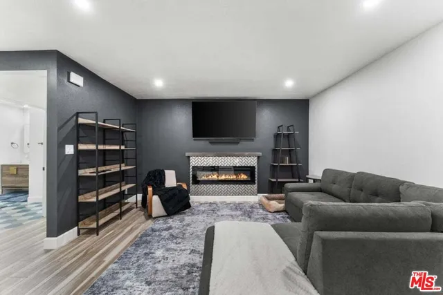 a living room with furniture a flat screen tv and a fireplace