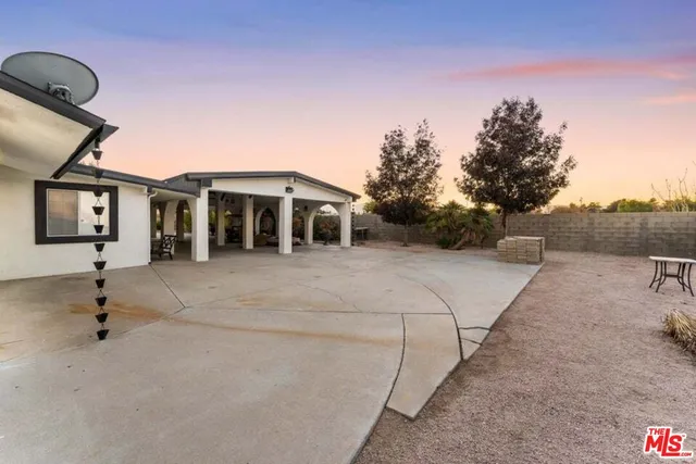 a view of a house with backyard and sitting area