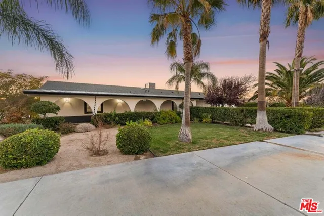 aerial view of a house with a yard and plants