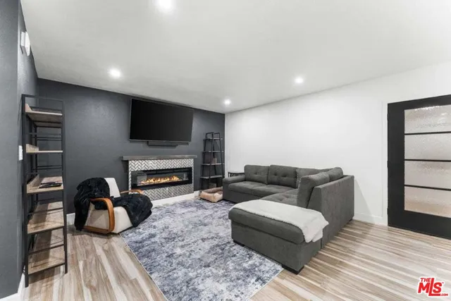 a living room with furniture a fireplace and a flat screen tv