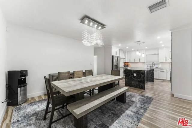a large kitchen with a table and chairs